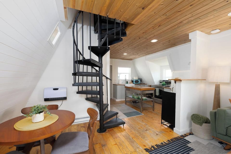 Small mid-century mod dining table by the spiral staircase!