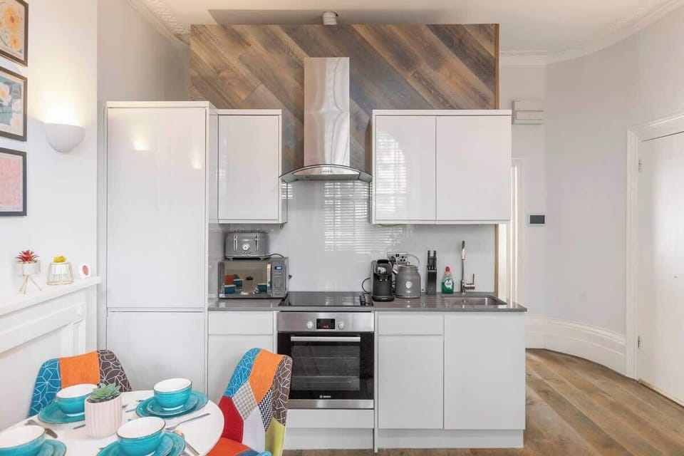 - Kitchen with oven, microwave, and appliances  
- White cabinetry and modern design for cooking  
- Functional space for preparing fresh meals  

