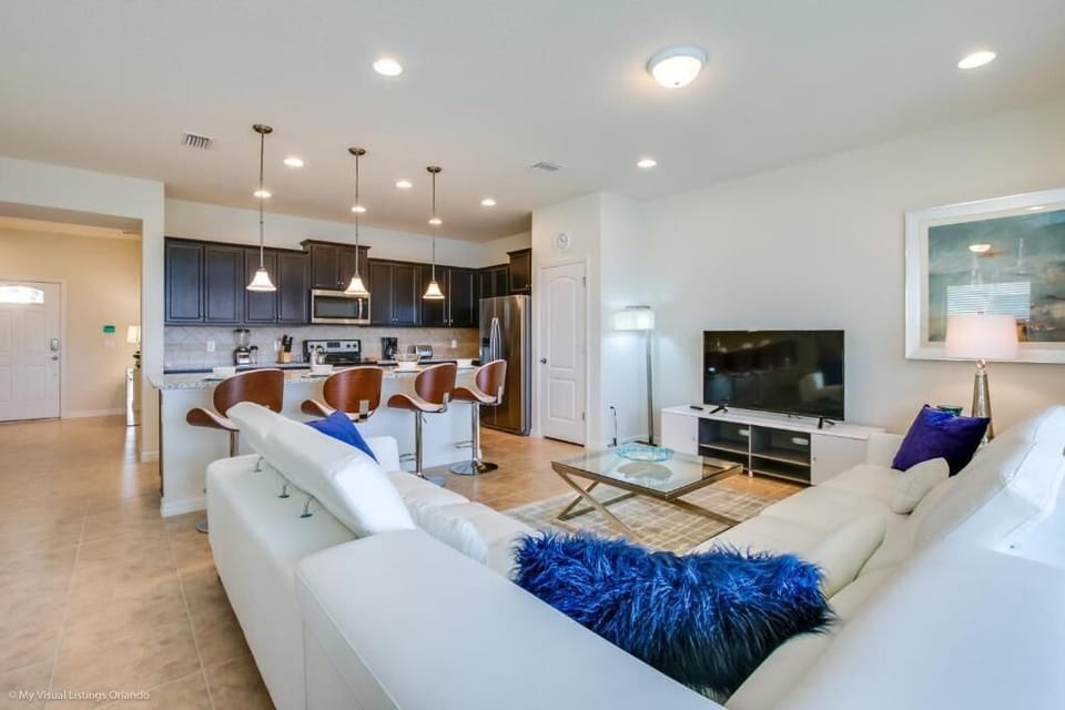 Stylish open-plan living with gourmet kitchen, sleek lounge, and breakfast bar.