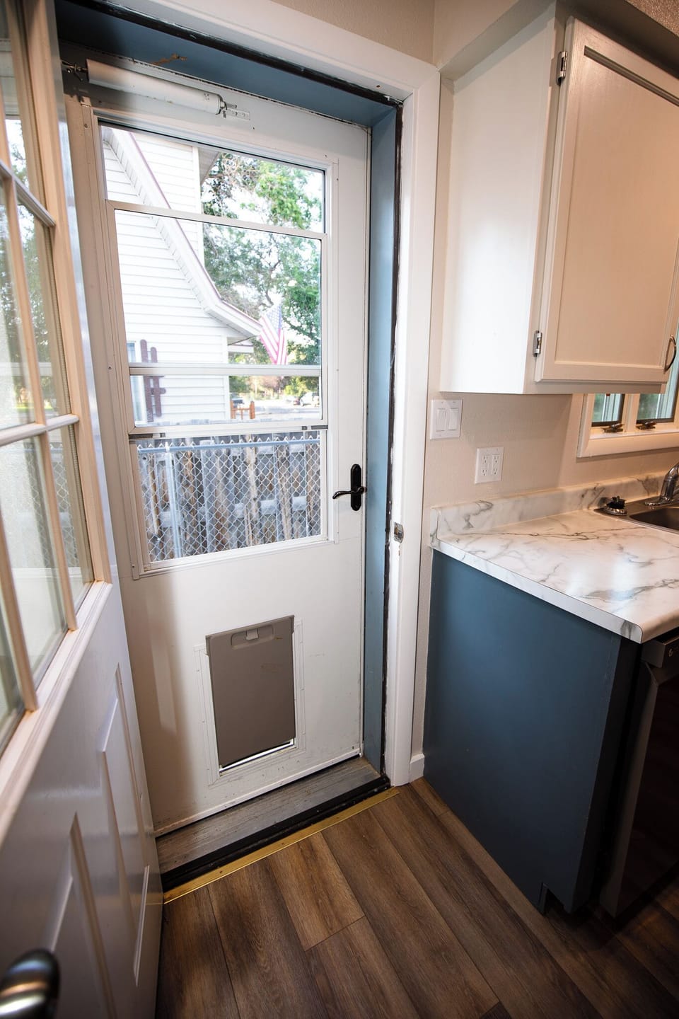 Side door by kitchen has a handy dog door for your 4-legged family members