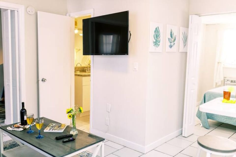 Experience the heart of home in our living room oasis. The chic center table anchors the space, offering a glimpse of the inviting dining table and the serene bedroom beyond. A seamless fusion of style and comfort awaits.