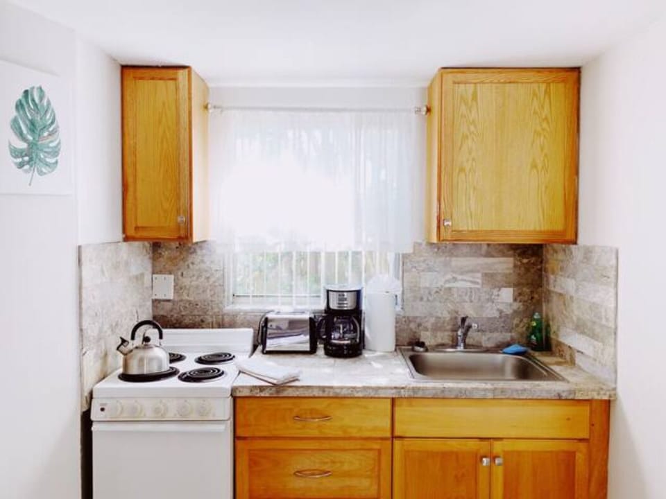 Step into culinary brilliance with a view of our well-lit kitchen. Every detail shines, from gleaming appliances to ambient lighting, creating a space where culinary artistry meets contemporary elegance.