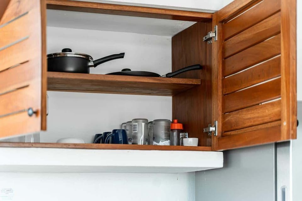 Kitchen with bar stools and full appliances
