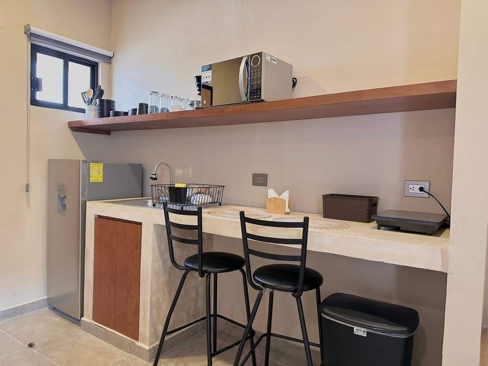 Kitchenette with breakfast bar, microwave and mini fridge