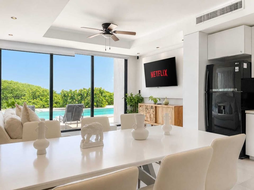 Living area with Smart TV and tropical garden view