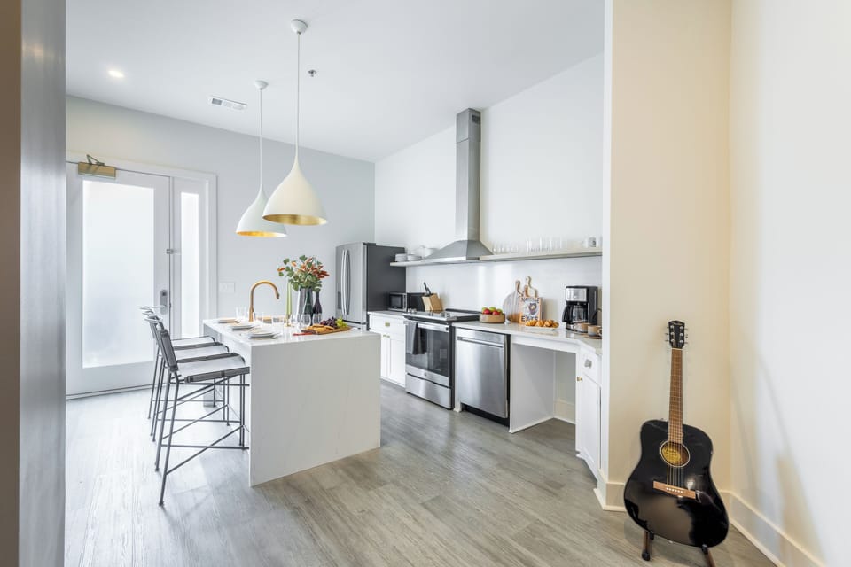 Fully equipped kitchen with a large island and barstool seating.