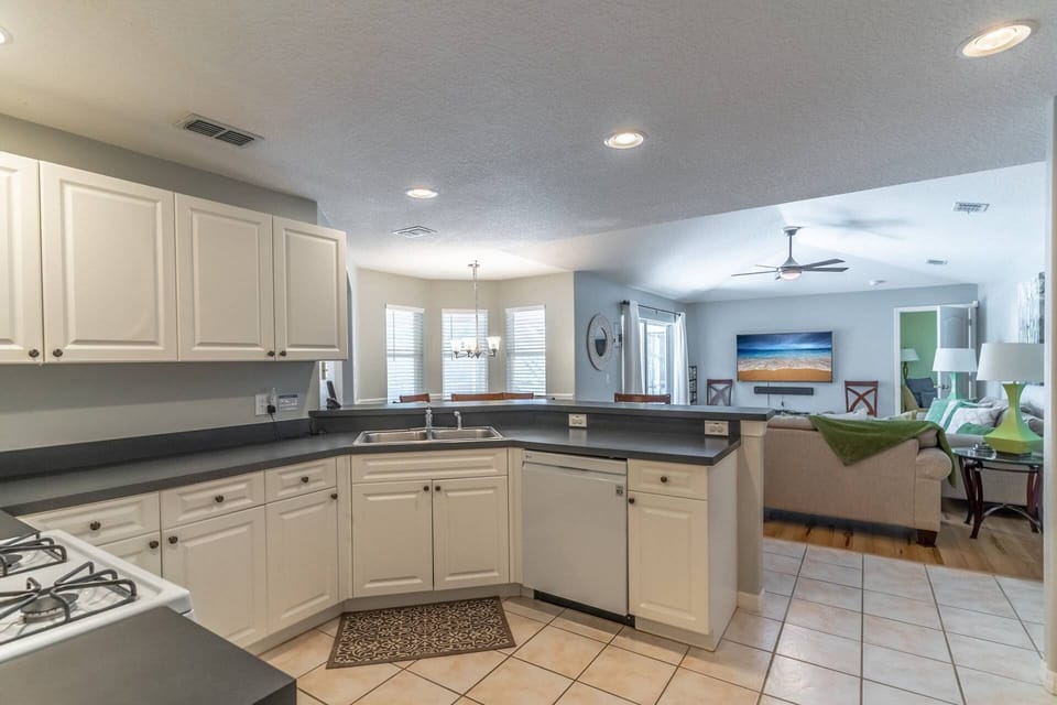Open kitchen with view of the breakfast nook, living area and view of the patio and pool
