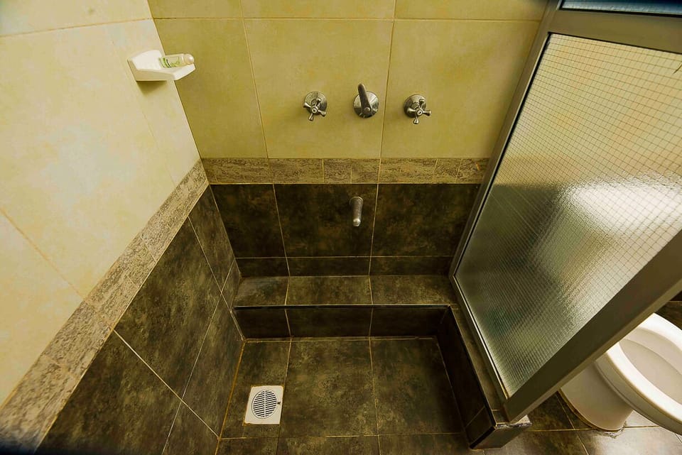 Shower, rainfall showerhead, slippers, towels