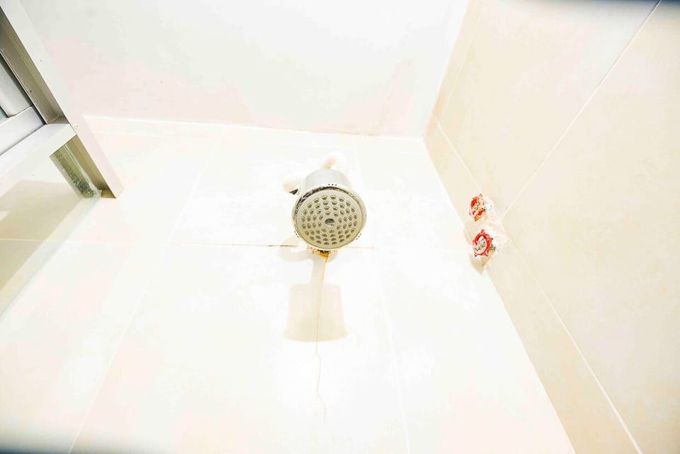 Shower, rainfall showerhead, slippers, towels