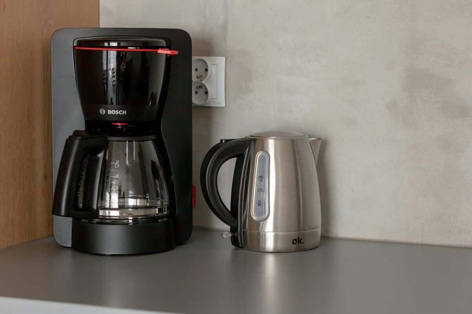 Electric kettle and coffee machine on the kitchen countertop.