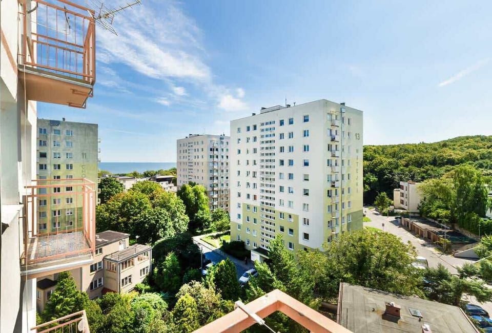Small balcony overlooking the surrounding area, and the Baltic Sea can be seen between the buildings.