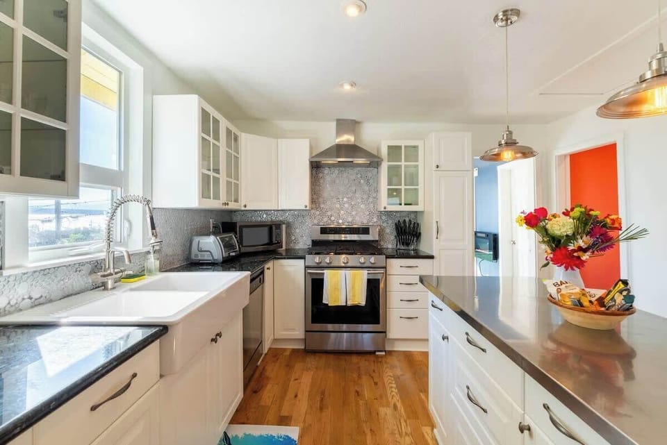 Spacious kitchen with stylish cabinetry, natural light, and a welcoming island for gathering.