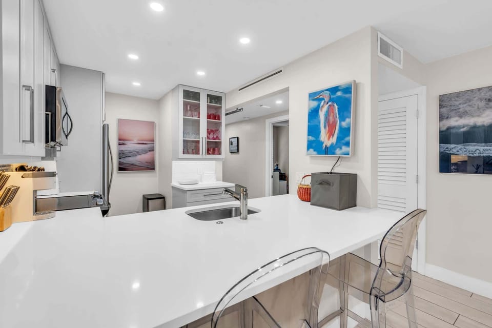 The kitchen counter can seat 2 additional people for dining