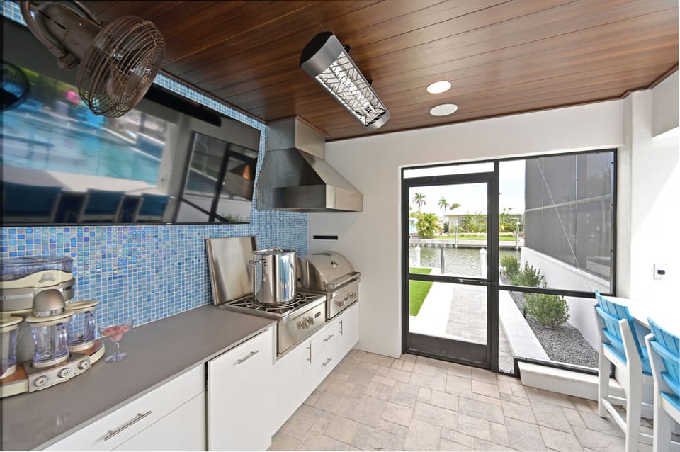 Covered outdoor kitchen with grill & large burner for seafood boils.