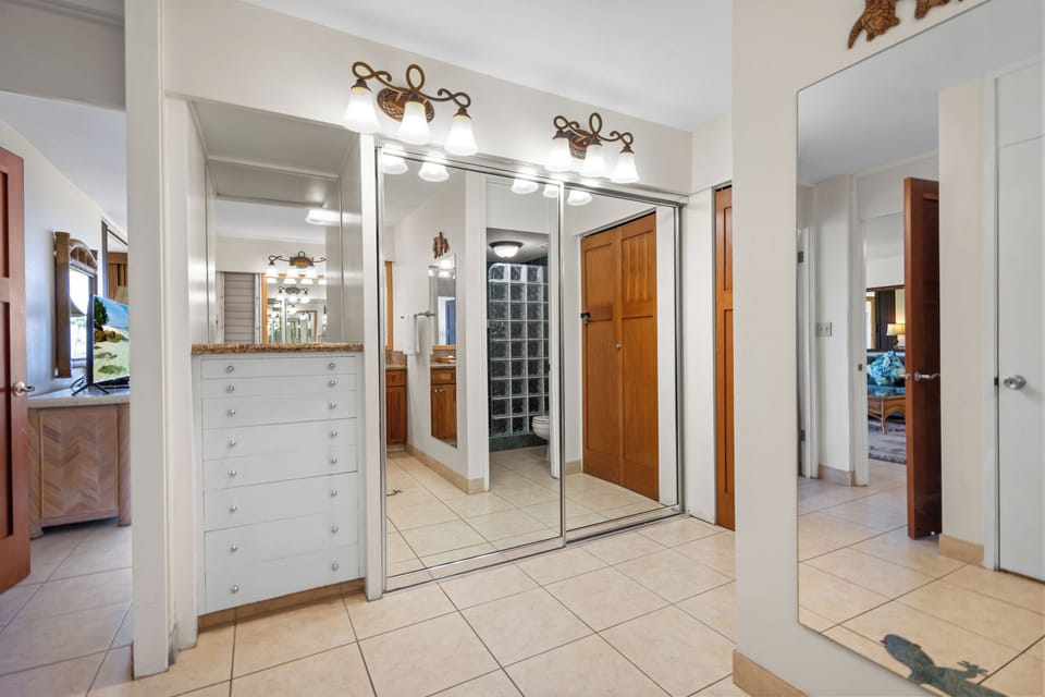 Bright vanity lights and mirrored closet doors reflect the spaciousness of your private suite, while elegant tile floors and generous storage keep your stay organized and comfortable.