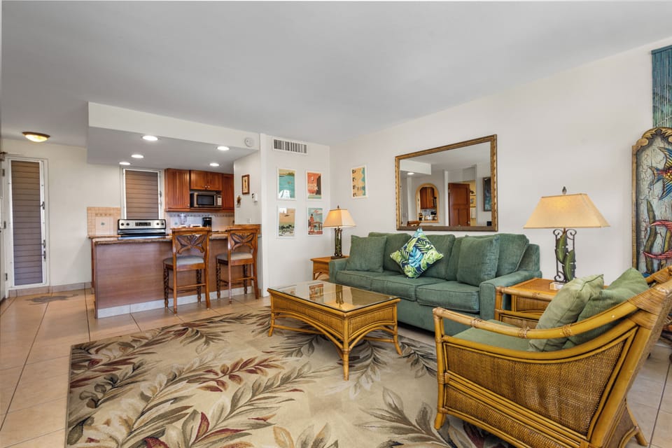 Picture yourself relaxing in this inviting open-concept living space, where tropical charm meets modern comfort. Sink into plush seating, enjoy island-inspired decor, and unwind in your fully-equipped kitchen retreat.