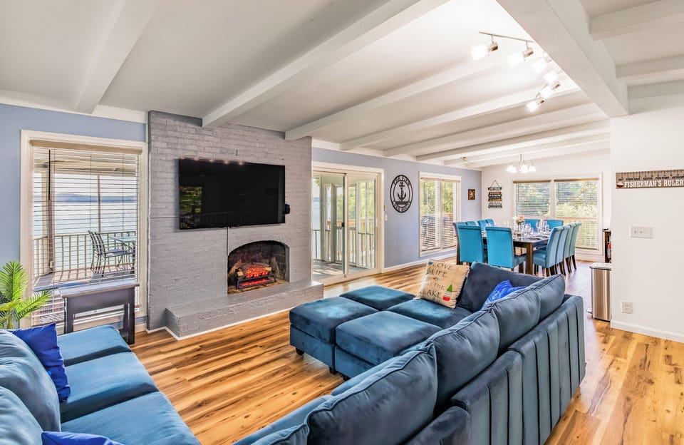 Relax on the oversized sectional beside the fireplace and large Roku TV in the main living room.