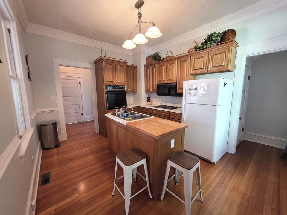Fully Stocked Kitchen with original oven and microwave.