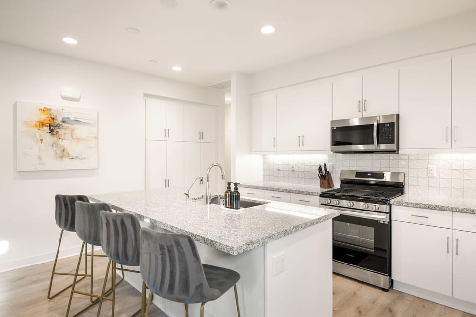 Kitchen island with seating for four makes it easy to chat with the cook or enjoy casual breakfast.