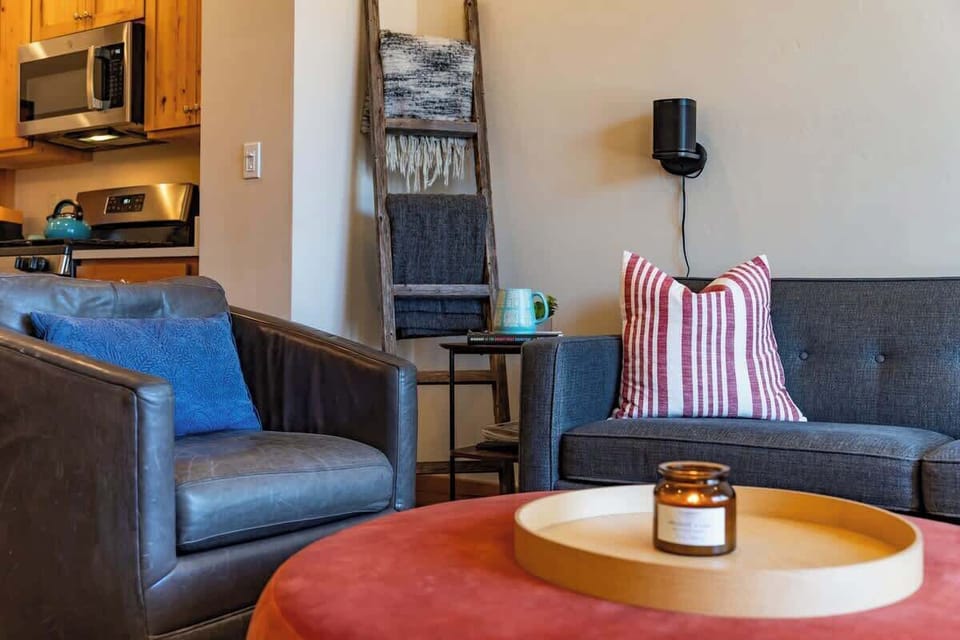 - Layered textures and soft lighting create a warm, relaxed vibe in this reading nook
- Striped pillow, cozy throw ladder, and candle tray add a boutique style finish
- Great spot for morning coffee or winding down after an adventure