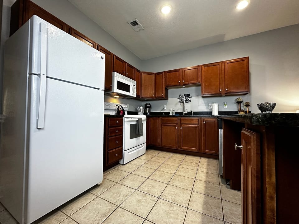 Enjoy a chef's paradise in our kitchen, featuring a fridge, oven, and all the tools for your culinary adventures!