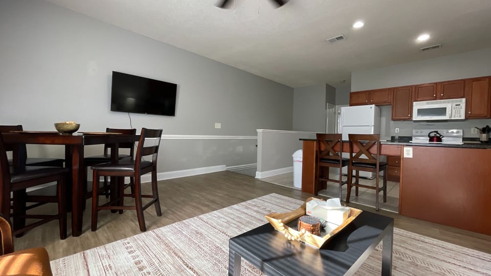 Relax in our clean living room, where the cozy kitchen view invites you to unwind