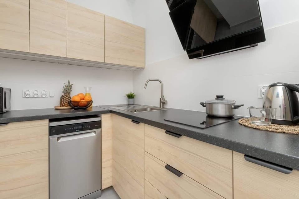 Kitchen with a microwave oven, an electric kettle and a refrigerator with a freezer.