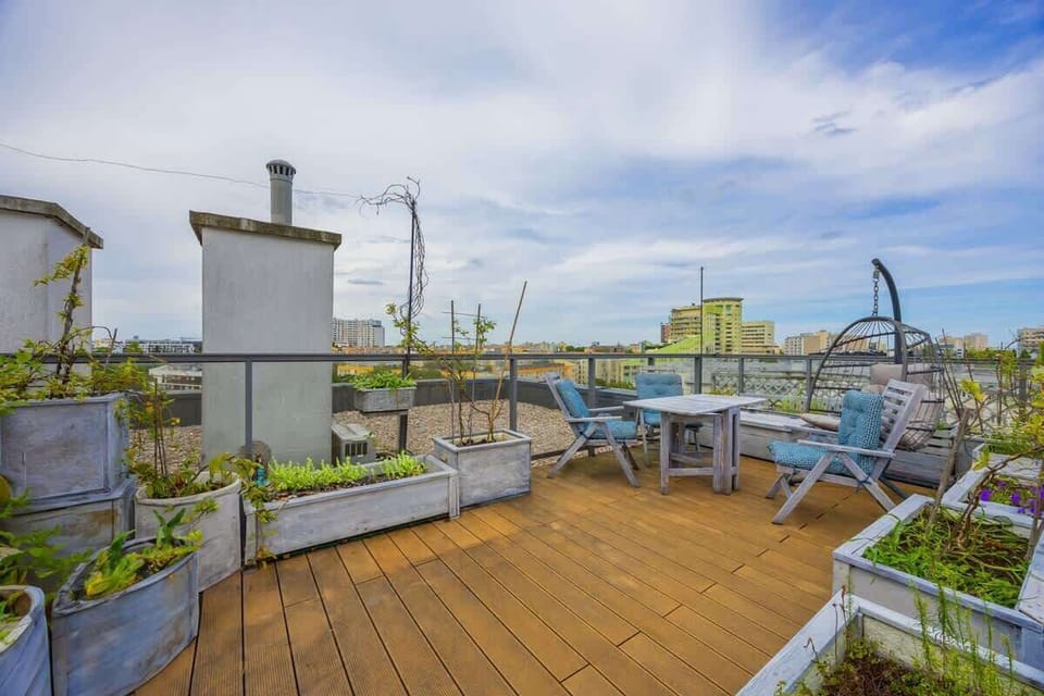 A modern outdoor terrace with wooden flooring and stylish seating. A relaxing space for enjoying the fresh air.