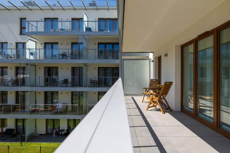 A bright balcony overlooking landscaped courtyards and residential buildings. Great for morning coffee or evening relaxation.