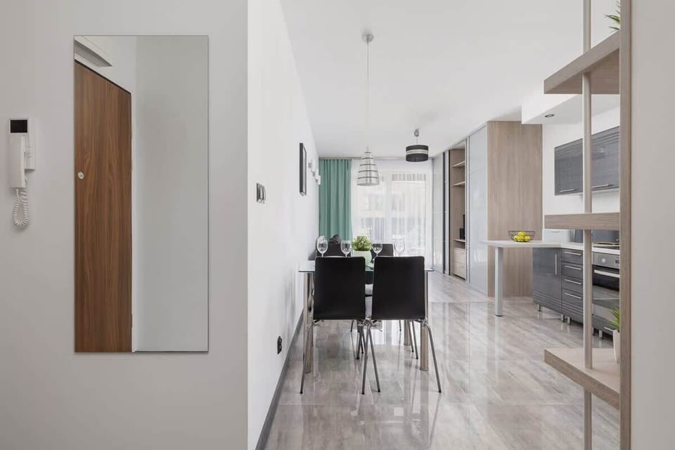 View from the entrance hallway into the kitchen and dining area, emphasizing the spacious, modern design.
