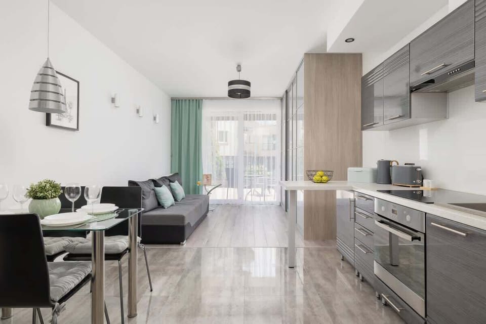 Sleek kitchen with grey cabinets, under-cabinet lighting, and modern appliances.