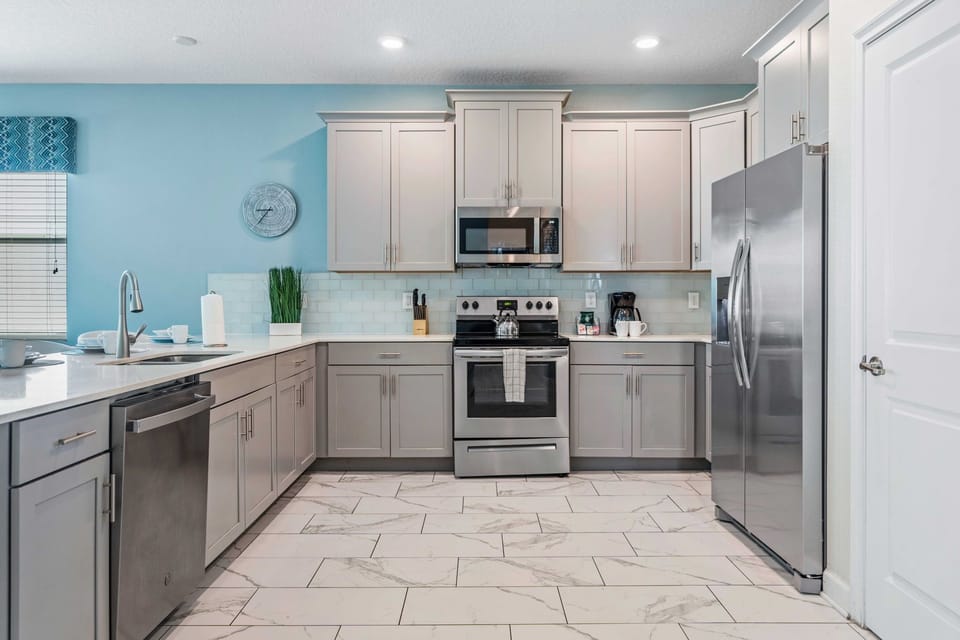 - Kitchen features a modern design with plenty of storage and counter space, perfect for preparing meals  - Integrated appliances contribute to the seamless and stylish appearance - Kitchen essentials are thoughtfully placed for easy access