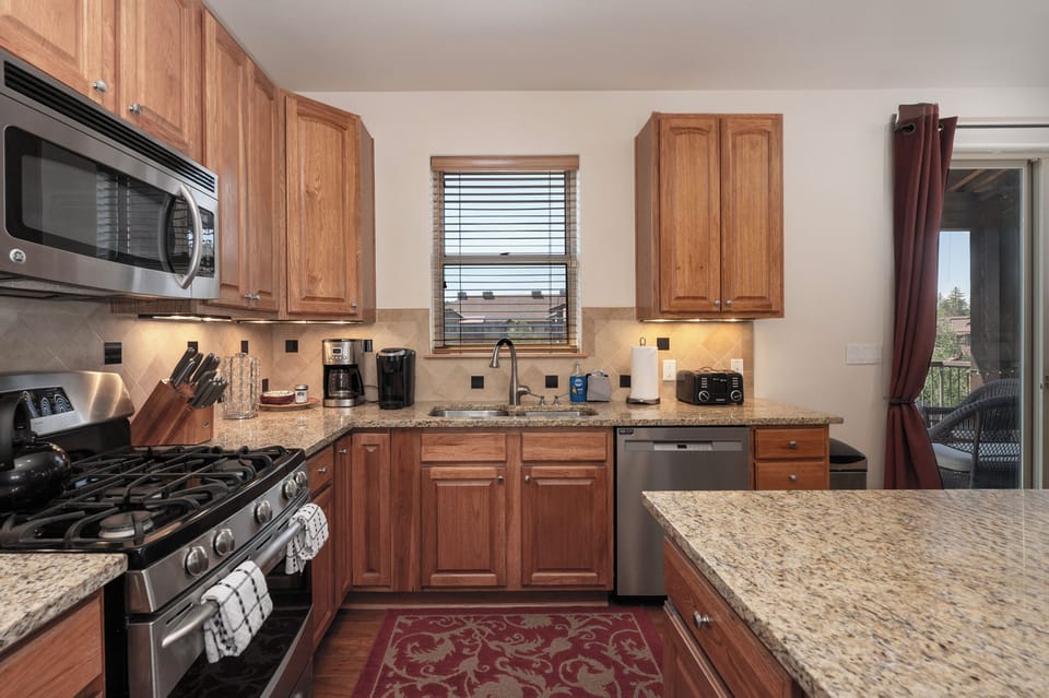 - Fully equipped kitchen with granite countertops and rich wood cabinetry
