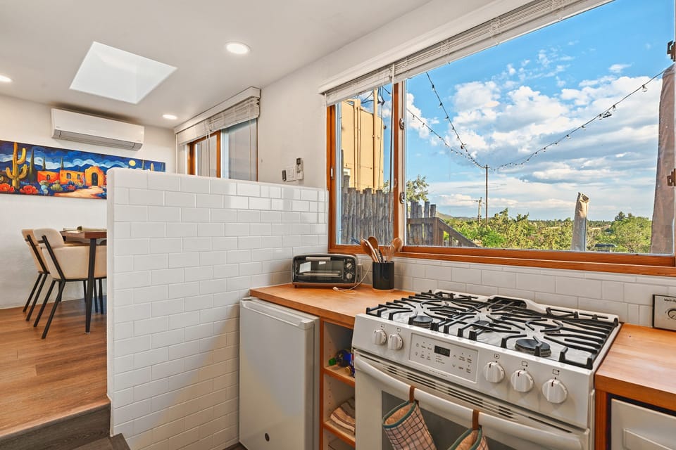 Toaster oven, fridge and full range. The dining area is beyond.