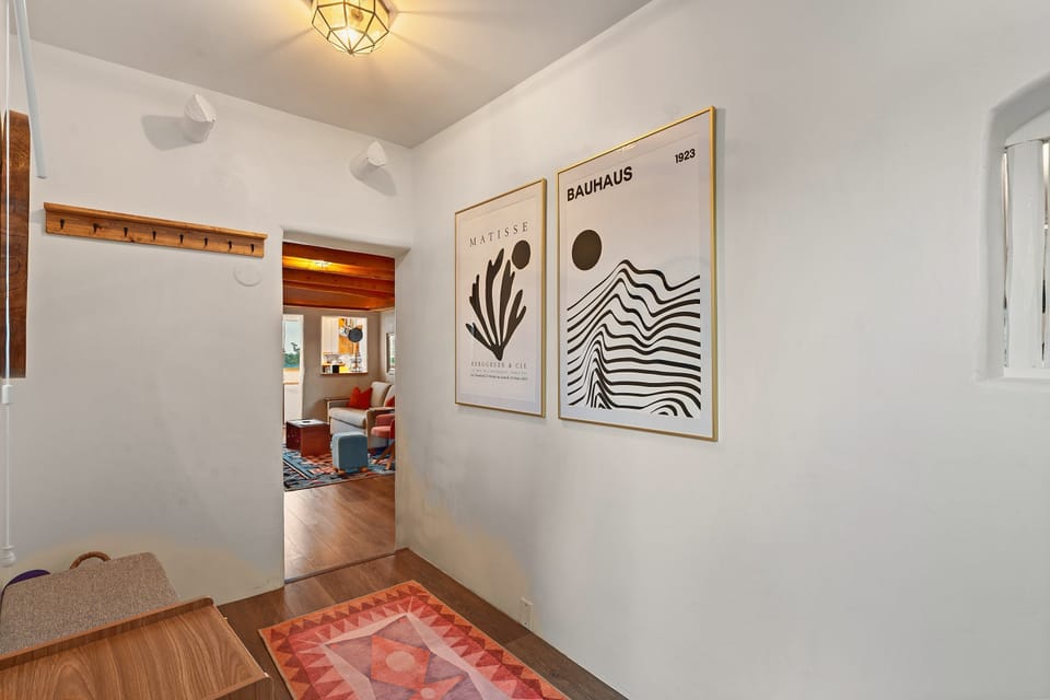 The entry, with hooks for coats and a look through to the living room.