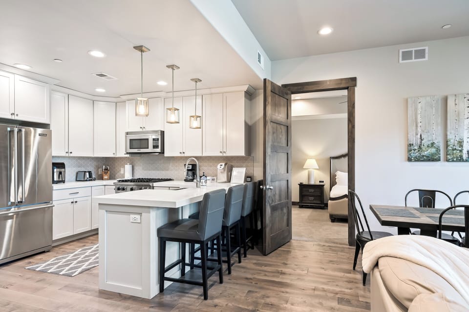Bright, modern kitchen with stainless appliances and a spacious island with seating—ideal for quick breakfasts or cooking together.