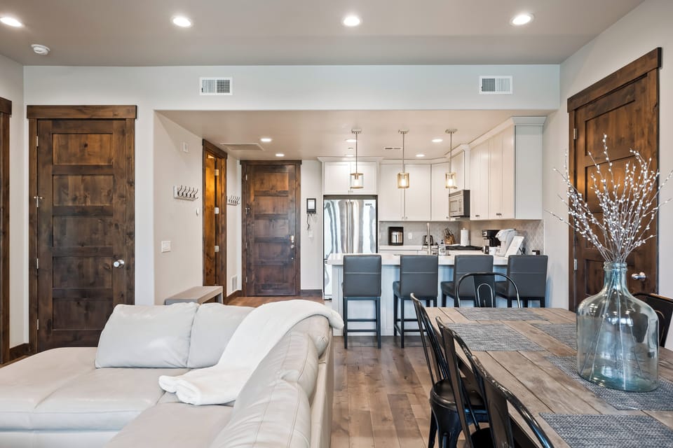 Airy great room combining living, dining, and kitchen spaces, designed for gathering, sharing meals, and making apres-ski memories.