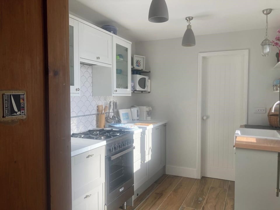 Leading on from the dining room is a Modern kitchen: newly installed Summer 2024. 