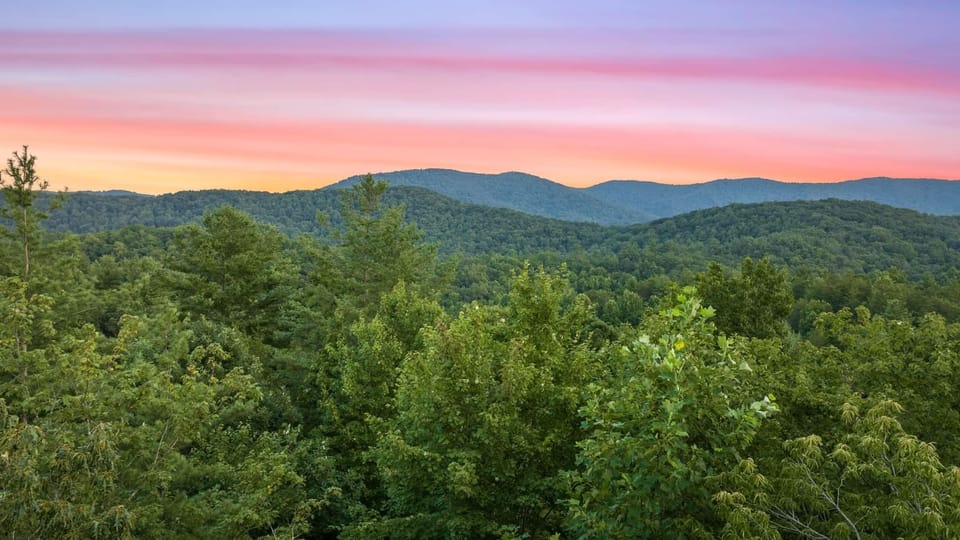 Marvel at stunning mountain and tree views as the sun sets, right from the comfort of our cozy cabin!