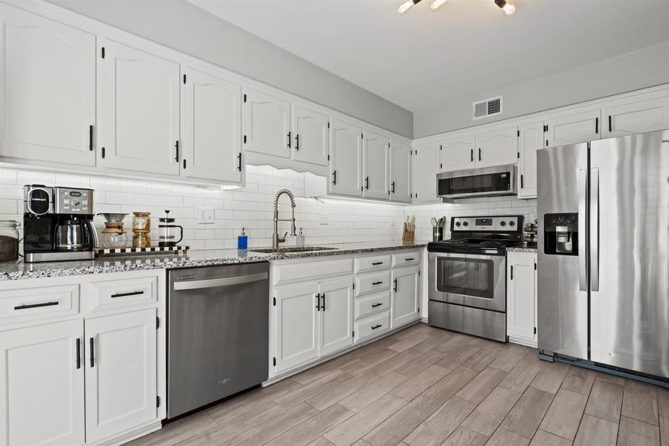 Spacious full kitchen with plenty of counter space, perfect for cooking meals or gathering with your group.