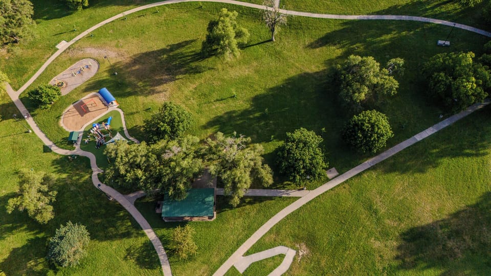 A bird’s-eye view of Westwood Park, featuring winding walking trails, open green space, and shaded areas perfect for morning strolls or relaxing afternoons.