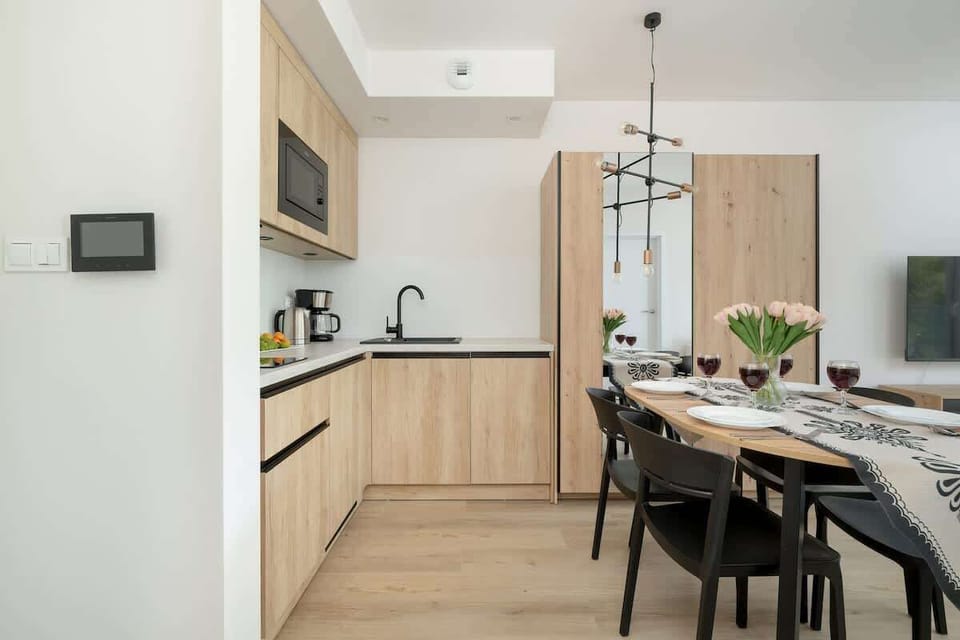 The sleek design of the kitchenette blending seamlessly with the living area.