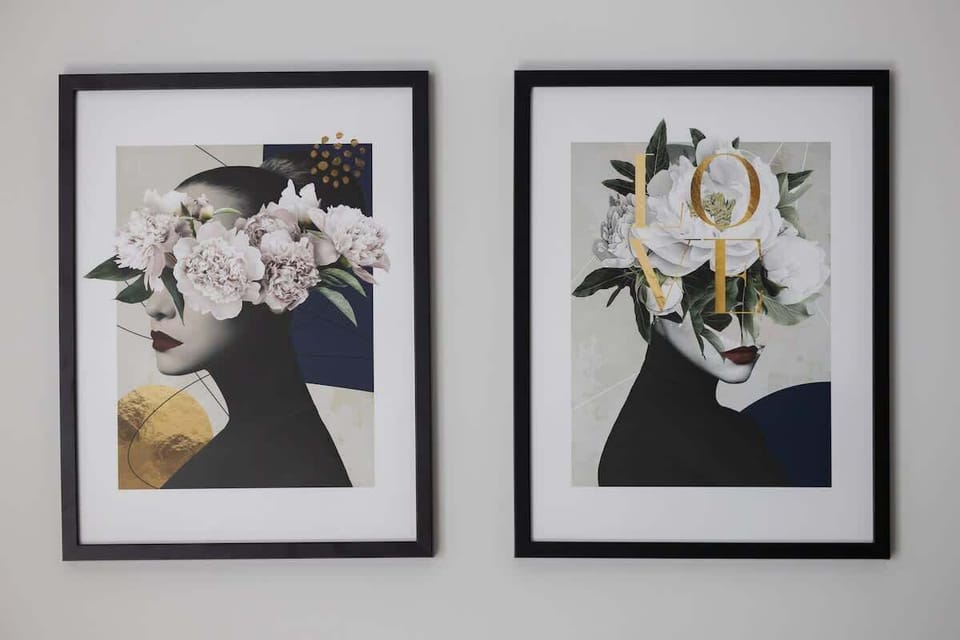 A close-up of three framed floral artworks hanging on a white wall. The artwork adds elegance and personality to the interior.