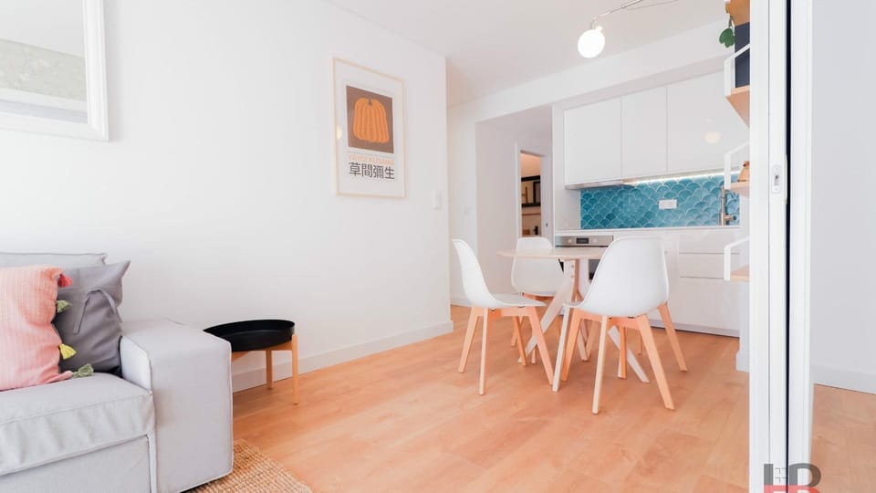 Step into a bright and inviting open-plan living area, seamlessly connecting a modern kitchen with sleek blue tiles to a comfortable dining space. This versatile hub is perfect for enjoying shared meals or relaxing after a day of exploration, combining st