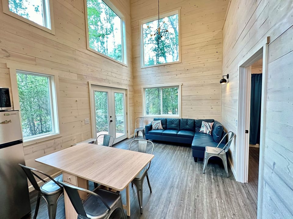 Comfortably seats six in the dining area, with a spacious living room couch—perfect for group gatherings and relaxation