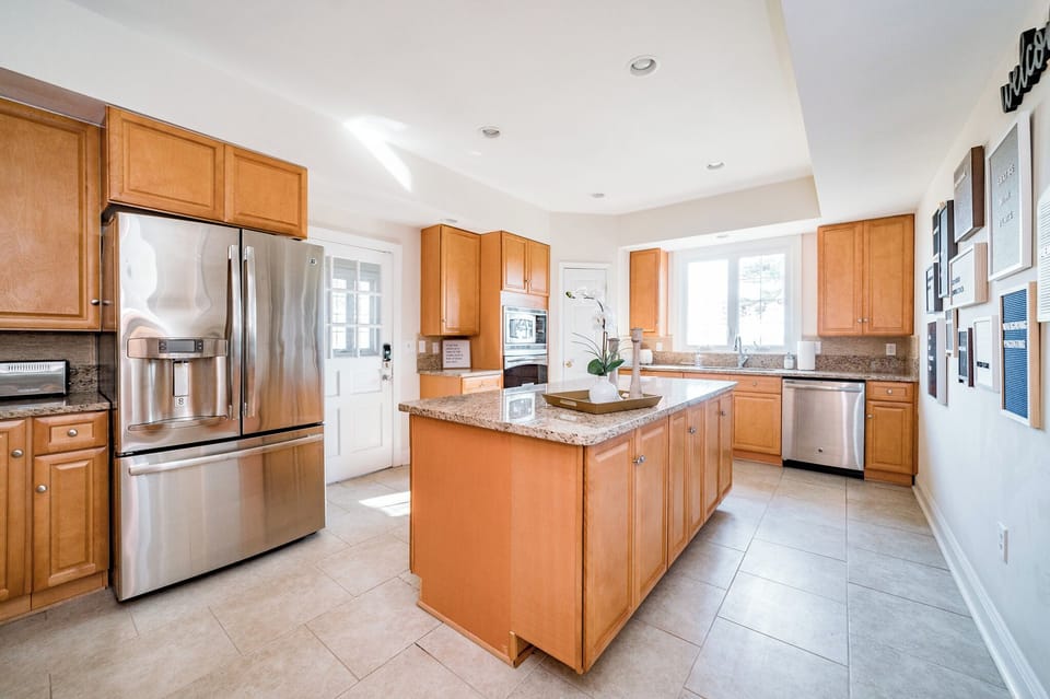 Spacious kitchen with large island is stocked and ready for cooking meals
