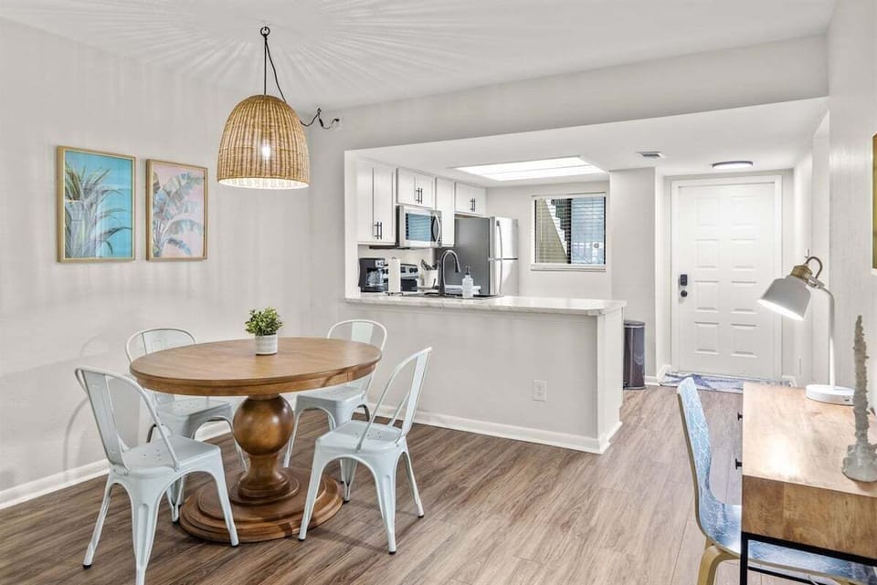 The dining area features a stylish table with seating for four, seamlessly connected to the kitchen for convenient and enjoyable meals.