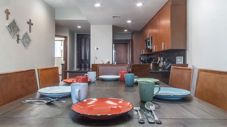 The dining table and kitchen.