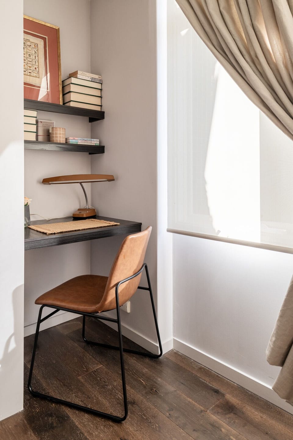 Tucked away in a quiet corner, this stylish workspace features a built-in desk, warm natural light, and everything you need to stay productive