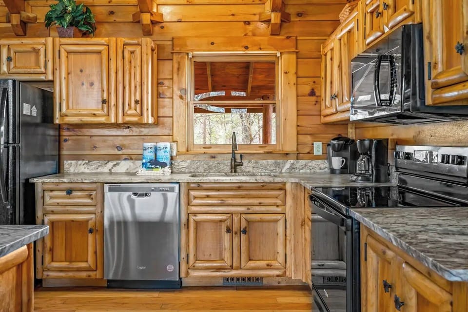 Hand made log wood cabinets! Cook with a forest view in this luxury kitchen!